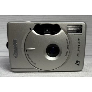 CANON ELPH LT 260 FOTOCAMERA DIGITALE PUNTA E SCATTA ARGENTO - Foto 1 di 8