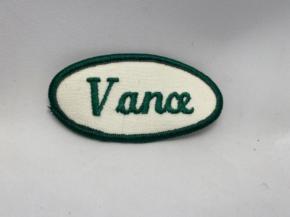 VANCE USED EMBROIDERED  SEW ON NAME PATCH TAG OVAL GREEN ON WHITE - Image 1 of 1