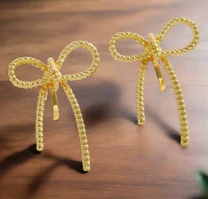 Clip on 1 1/4" gold textured indented bow tie earrings - Picture 1 of 4