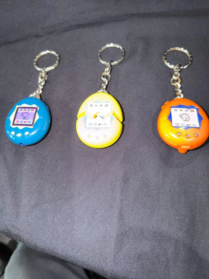 3 Vintage 1997 Tamagotchi McDonalds Bandai Keychains Lot - ORANGE/ YELLOW/ BLUE - Image 1 of 2