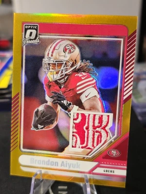 2024 Panini Donruss Optic Threads Gold #DTB-BAK Brandon Aiyuk #10/10 🔥49ers  - Image 1 of 4