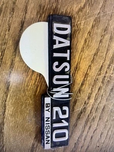 A559. 1979-1982 Datsun 210 Emblem - Picture 1 of 2