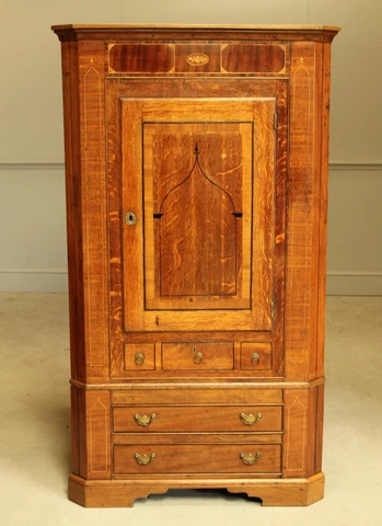 A George III Oak and Mahogany corner cabinet Cover