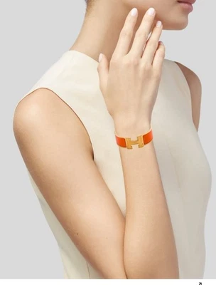 Pulsera Hermes Clic Clac H PM Esmalte Naranja y Oro Foto 1 de 3