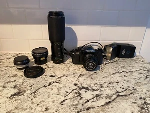 canon a1 film camera 35mm, avec lens FD 50mm 1:1.4, plus 2 zoom et 1 flash - Photo 1 sur 7