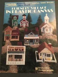 Leisure Arts Friendly Village In Plastic Canvas School Church Store #1286 - Picture 1 of 2