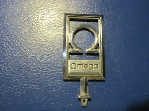 Adorno capucha Omega vintage - Imagen 1 de 2