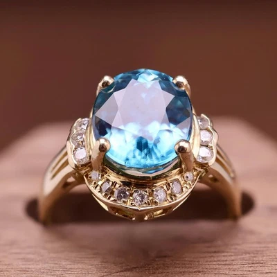 Anillo de colección K14 YG corte brillante ovalado topacio azul suizo y halo de zafiro talla 9 Foto 1 de 4