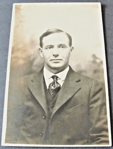  Serious looking Man - Real Photo Postcard-Stamp Box-AZO (1918-1930).     - Picture 1 of 2