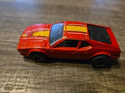 Coche diecast Hot Wheels BMW M-1 Real Riders 1982 rojo con rayas amarillas Malasia Foto 1 de 4