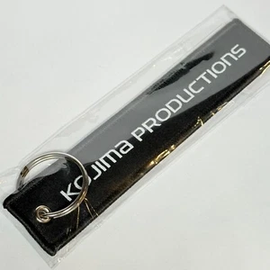 Kojima Productions flight strap keychain charm (Black version) - Official NEW - Picture 1 of 4