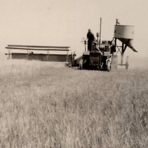 1920s Combine Towed By Smaller Tractor At Grain Harvest: Vintage Photo Snapshot