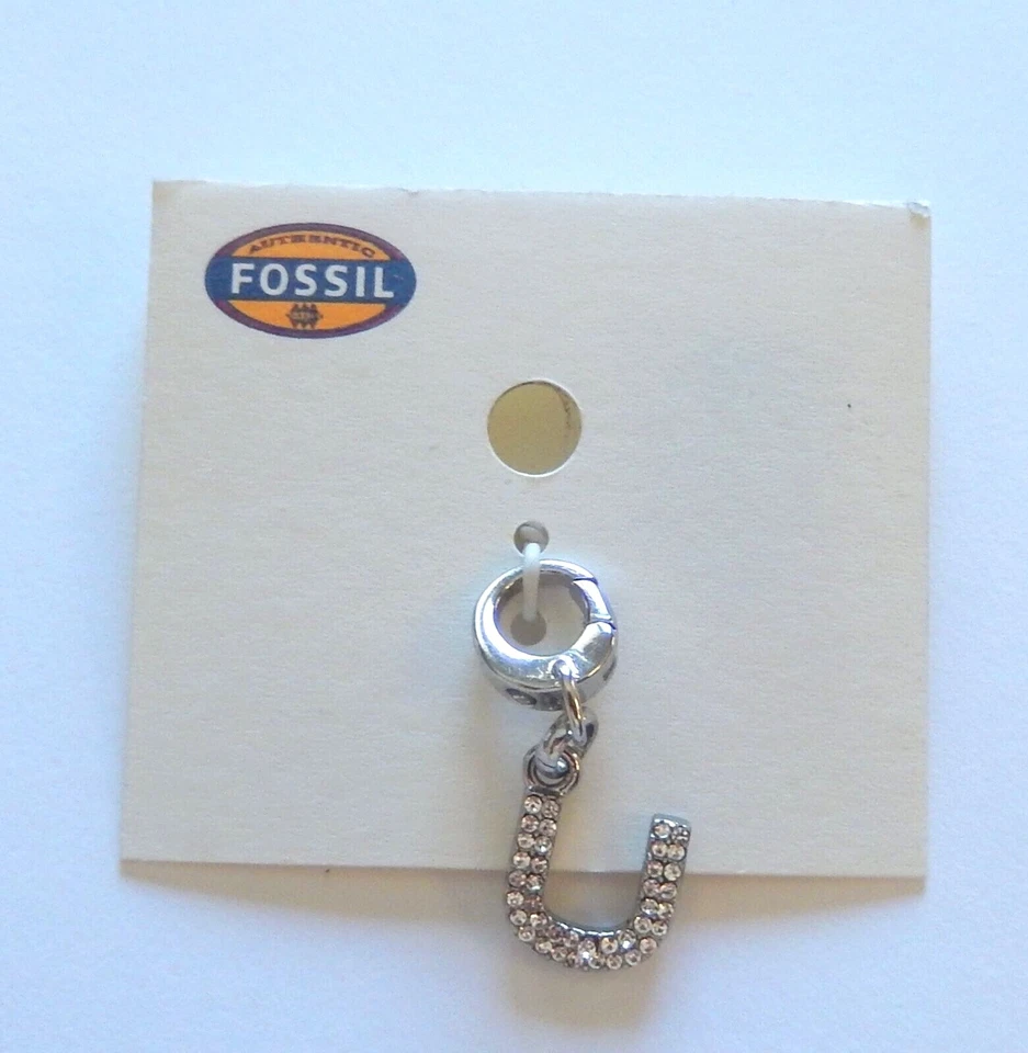 Dije icónico fósil - color plata - letra U - pequeñas piedras brillantes Foto 1 de 1