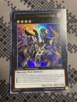 Evilswarm Ourobors Misprint No DT Foil Ultra Rare NM DT07-EN092 - Image 1 of 2