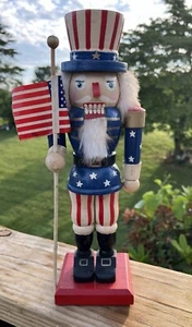 UNCLE SAM HOLDING AMERICAN FLAG PATRIOTIC NUTCRACKER 12 “ - Picture 1 of 12