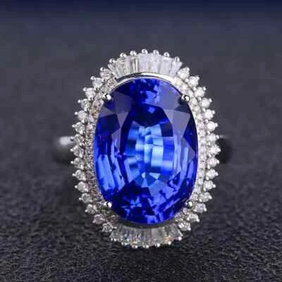 Anillo de compromiso con halo de diamantes de tanzanita azul corte ovalado de 5 quilates enchapado en oro blanco de 14 k Foto 1 de 4