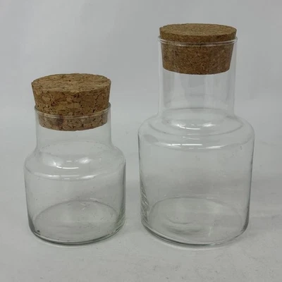 Set of 2 Cylinder Shaped Clear Glass Jars With Cork Lids 5" and 7" - Image 1 of 4