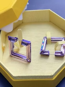 Orecchini a cerchio Swarovski Lucent viola - Foto 1 di 9