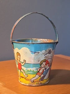 Tin Beach Pops Candy Container, Lithographed Kids on the Beach Sand Pail 4.75”H - Picture 1 of 8