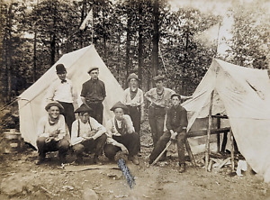 CAMPING GROUP OF YOUNG MEN AT CAMP, TENTS, GUNS COWBOYS ANTIQUE PHOTOGRAPH RPPC