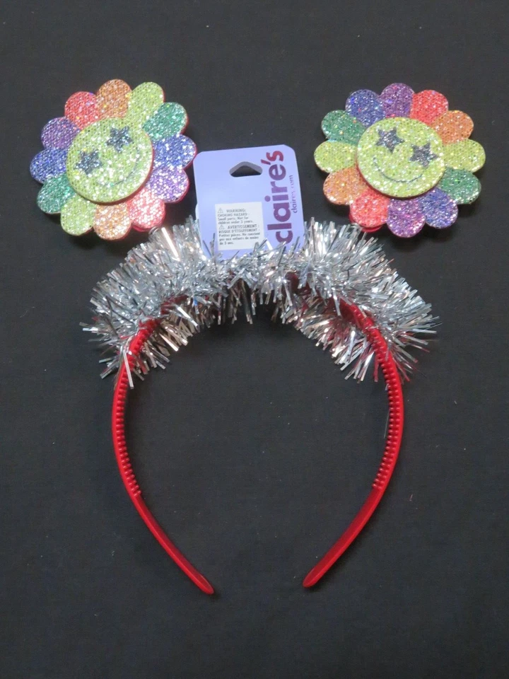 (1) Diadema multicolor con flor cara sonriente de Claire's Foto 1 de 1