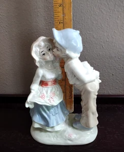 Vintage Porcelain Girl and Boy Kissing on the Cheek Holding a doll blues/whites - Picture 1 of 8