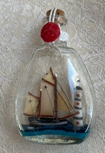 DELIGHTFUL SMALL SHIP IN A BOTTLE - WITH LIGHTHOUSE - 3.5 INCHES / 9 CM TALL - Picture 1 of 3