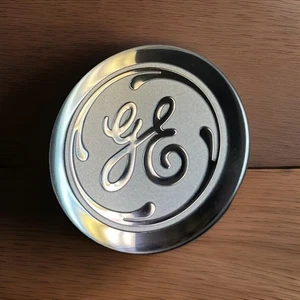 GE Badge Nameplate WR02X35066 1.50"DIAx 0.46" Thick, Chrome Finish w backer, New - Picture 1 of 2