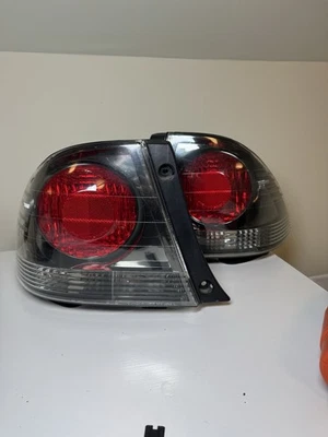 Luces traseras cromadas oscuras OEM Lexus IS300 2001-2005 Foto 1 de 4
