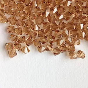 12 x 6 mm Swarovski Kristall, Stil 5031 Doppelkegel Perlen - Heller Colorado Topas. - Bild 1 von 1