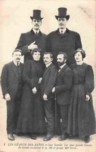 jxf29f 2 GIANT men pose with 5 people of average height unusual antique postcard - Picture 1 of 2