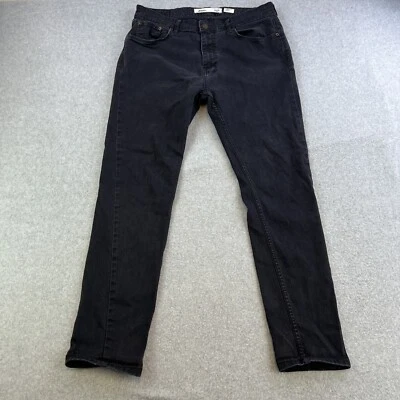Pantalones de mezclilla negros cónicos elásticos talla 34R Burton Menswear London para hombre Foto 1 de 4