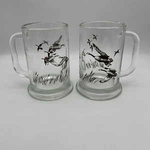 2er Set Avon Glas Bierkrüge Steine mit braunen Gänsen fliegende Jagd Vögel 1982 - Bild 1 von 6