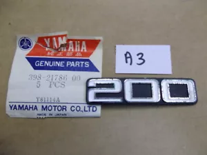 Yamaha RD200 Side Cover Badge NOS Genuine Tank Emblem 398-21786-00 YCS5 CS5 #A3 - Foto 1 di 5