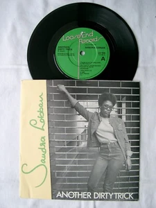 SANDRA LOBBAN - Another Dirty Trick 7" - LE 104 - 1983 UK - Picture 1 of 2