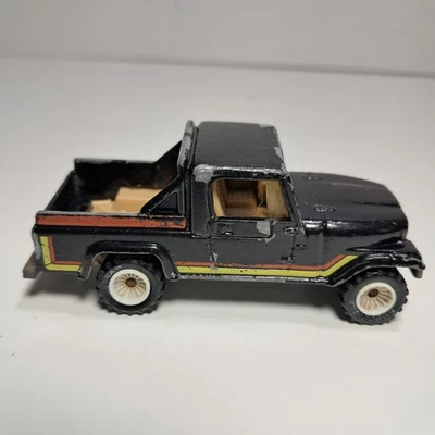 Camión Jeep Scrambler 1982 Hot Wheels de colección 1/64 diecast negro naranja amarillo rayas Foto 1 de 4