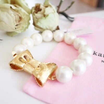 Auténtico Brazalete KATE SPADE Nueva York Todo Envuelto Vidrio Perla Oro Arco $98 Foto 1 de 4