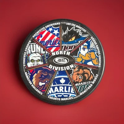 AHL North Division Souvenir Puck - Abbotsford Heat Era 2009-11 - InGlasCo - Image 1 of 3