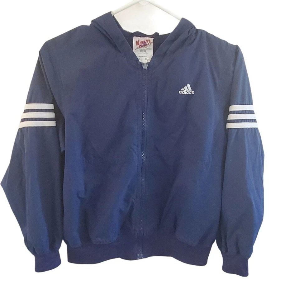 Chaqueta cortavientos Adidas para niñas talla M con capucha cremallera bolsillos ligeros azul blanco Foto 1 de 4