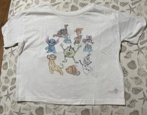 Gebrauchtes Disney 100 weißes bauchfreies Oberteil Jugend Größe 6 Simba Mirabel Olaf Stitch - Bild 1 von 4