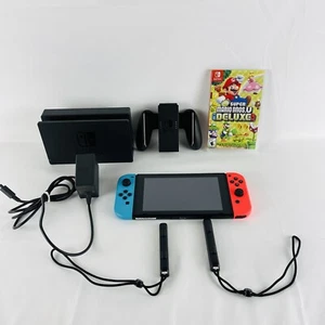 Nintendo Switch Konsole mit Neon-Rot und Neon-Blau Joy-Con mit Mario Spiel - Bild 1 von 21