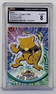 Abra #63 1999 Pokémon Topps Serie 1 - 2da impresión etiqueta negra tarjeta graduada CGC 8 - Imagen 1 de 5