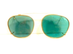 older clip on style pair of sunglasses with gold color frames and green lenses - Picture 1 of 7