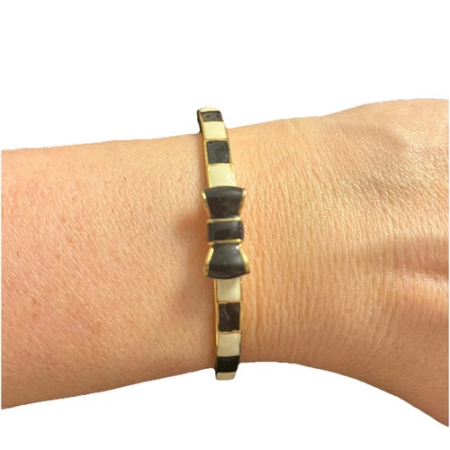 Bracciale Kate Spade Take A Bow tono oro bianco e nero. Classy