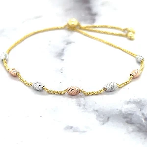Pulsera de amistad de cuentas ovaladas de CC de oro tricolor de 14 K de 9,25" estacionada - Imagen 1 de 12