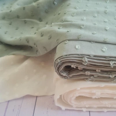 Viscose dobby textured spot polkadot dress fabric. Sage green and white - Image 1 of 4