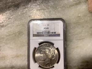 1926 Silver Peace Dollar MS63 - Picture 1 of 2