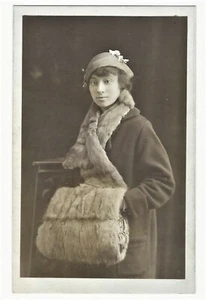 A YOUNG WINTERIZED ETHNIC WOMAN AND HER GIANT MUFF - Picture 1 of 3