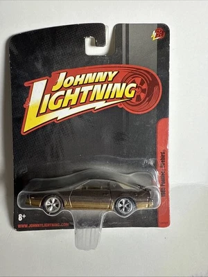 Johnny Lightning 1985 PONTIAC FIREBIRD TRANS AM Brown-Gold w/Chrome 5 Spoke I9 - Image 1 of 2