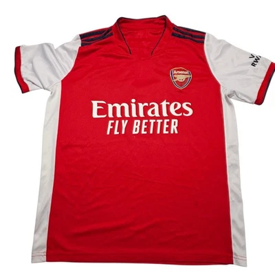 Camiseta de fútbol pequeña Arsenal Fly Emirates Victoria Concordia Crescit adulto Foto 1 de 4